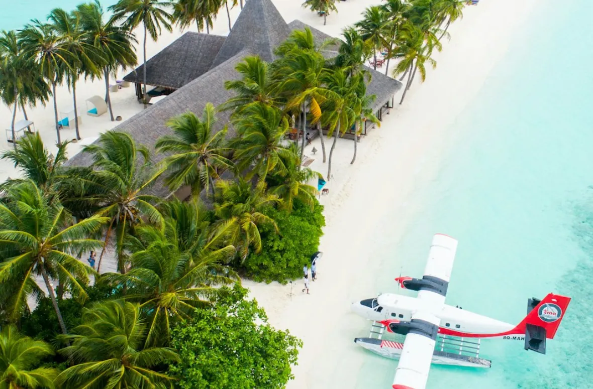 Aerial view of tropical island and seaplane on Mircari travel blog.