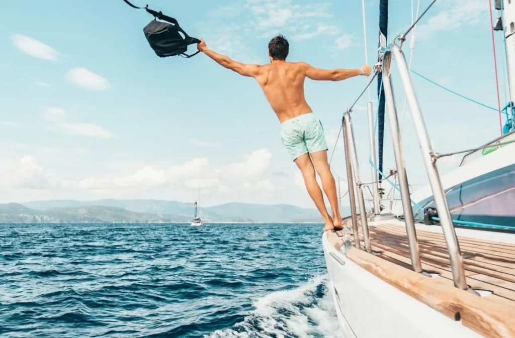 Man on a yacht embracing the sea breeze on Mircari travel blog.