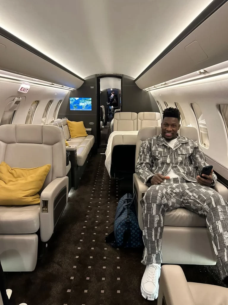 A private jet interior with a seated man and "mufcmpb."